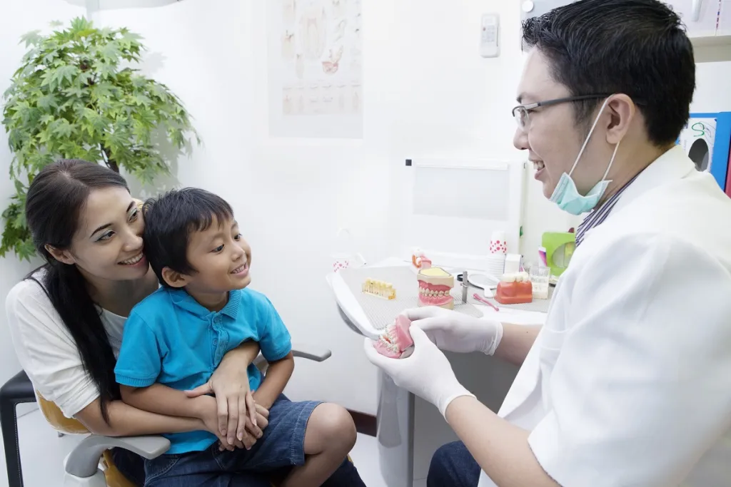 Doctor talking to a child about implant