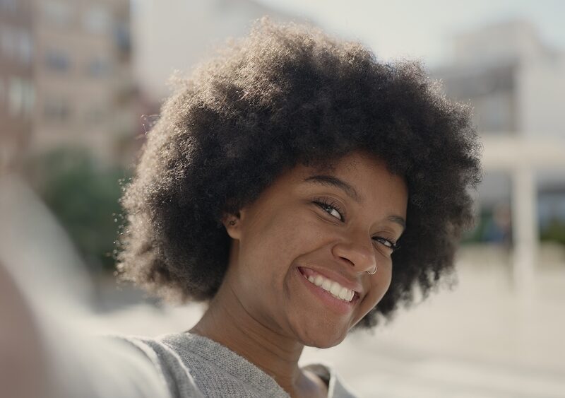 Smiling woman showing a bright, natural-looking smile after cosmetic dental care in Bethesda, MD