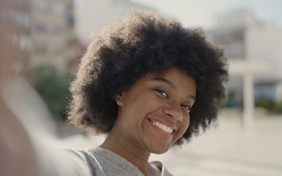 Smiling woman showing a bright, natural-looking smile after cosmetic dental care in Bethesda, MD