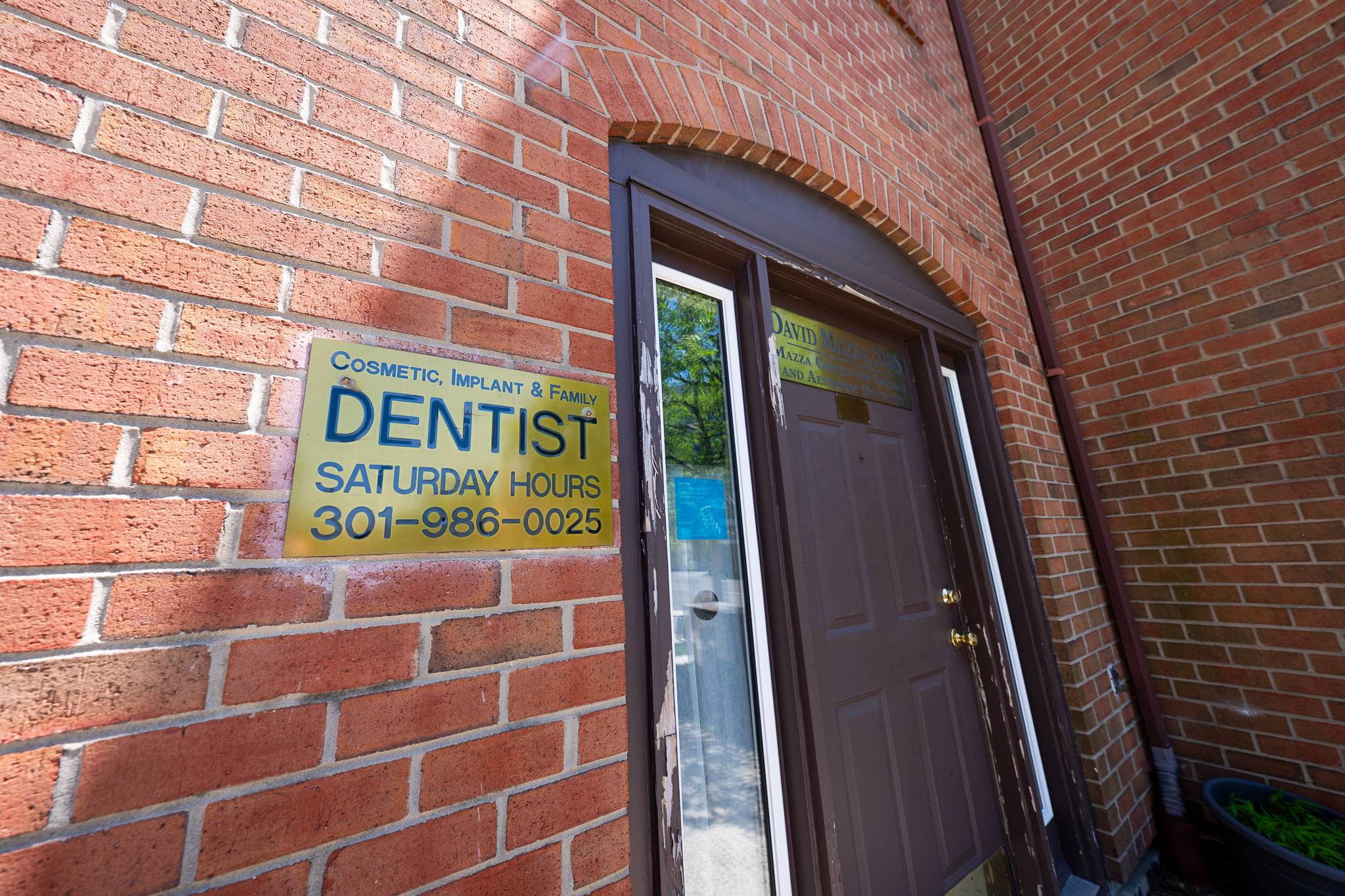 Entrance to Mazza Center for Implant and Aesthetic Dentistry in downtown Bethesda, MD Brick entrance to Mazza Center for Implant and Aesthetic Dentistry with dentist and Saturday hours sign in Bethesda, MD
