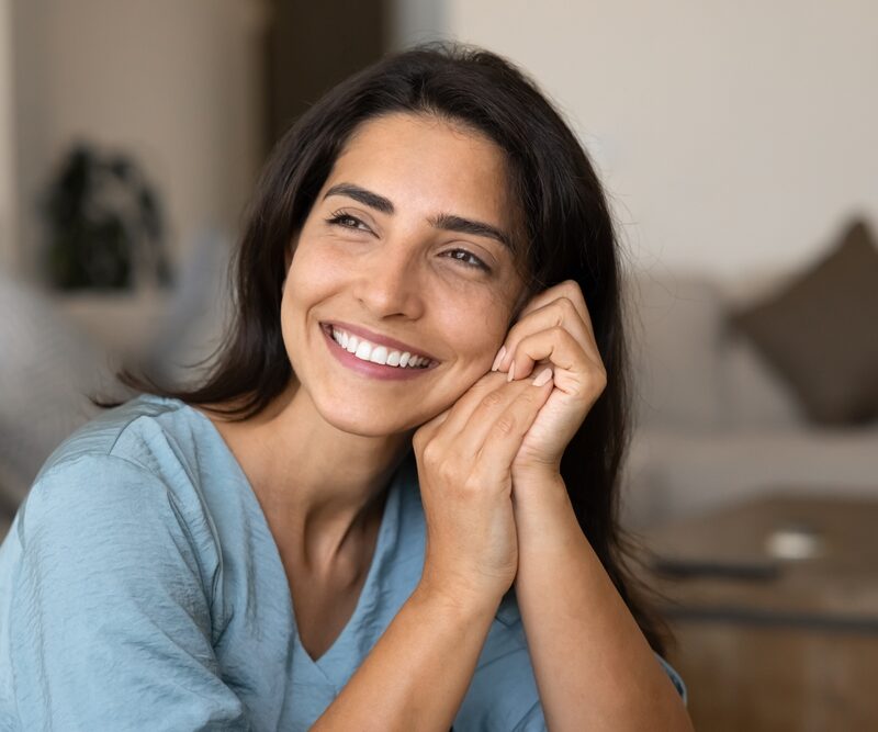 Smiling woman representing confidence with implant-supported dentures in Bethesda, MD