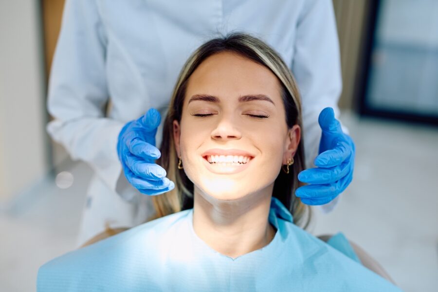 Smiling female patient during a restorative dental examination at a practice in Bethesda, MD